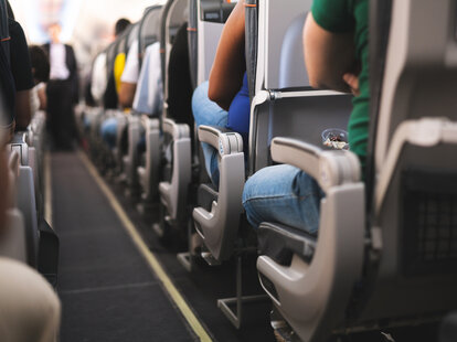 Interior of airplane with passengers sitting in seats