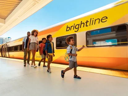 A family boarding a Brightline train in Florida.