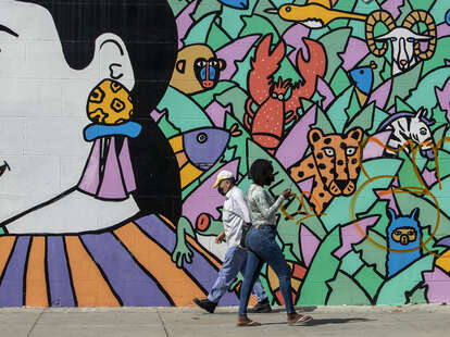 Pedestrians walk past a mural near 3rd St. in Koreatown.