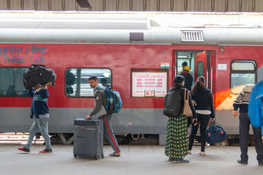 Passengers boarding train, India