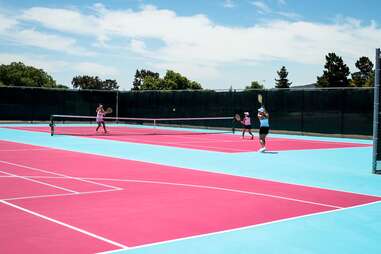 A hot pink and blue tennis court at Madonna Inn