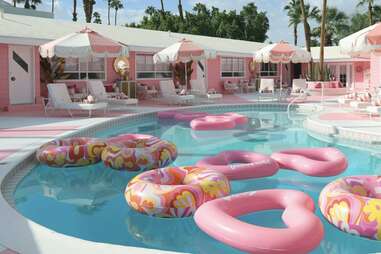 The pink pool deck and pool filled with floats at the Trixie Motel.
