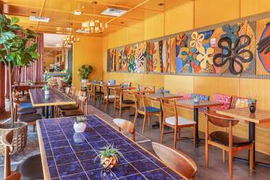 A groovy pool deck with lots of color and tables. 