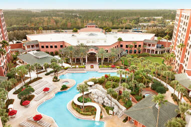 The pink pool deck and building of the Caribe Royal Orlando