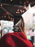 person holding up a phone at city scenery for an instagram story 