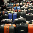 Rows of luggage at baggage claim after major flight delays. 