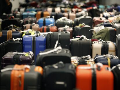 Rows of luggage at baggage claim after major flight delays.