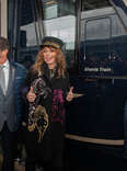 Shania Twain stands with two men next to the new train named after her in Switzerland.