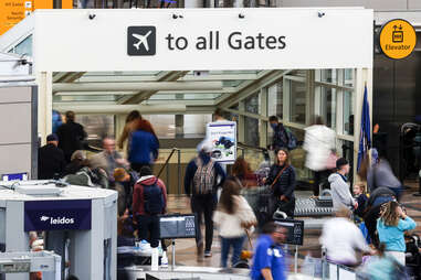 Travelers head toward their gates after passing through a TSA security checkpoint at Denver International Airport