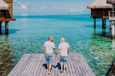 men holding hands island resort