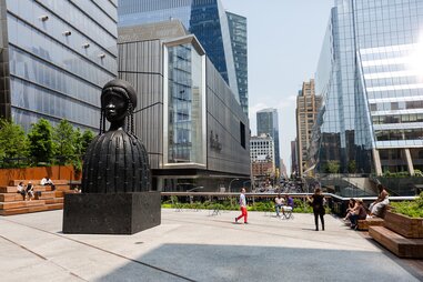 people walking around sculpture on high line
