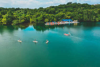 overview shot of Lady Bird Lake with paddle boarders.