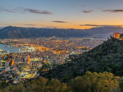 Palermo, Sicily, Italy skyline overlooking the port at sunset.