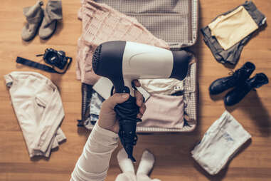 packing hair dryer in suitcase