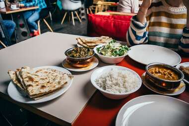 Person sitting at table in an Indian restaurant