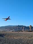 plane flying away from palm springs international airport