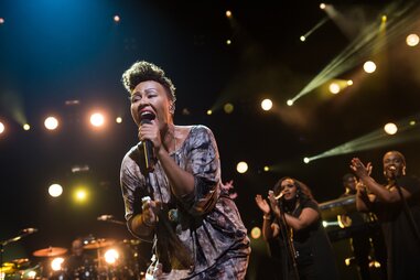 a woman performing with background singers