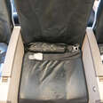 The middle seat with its armrests on an economy flight airplane