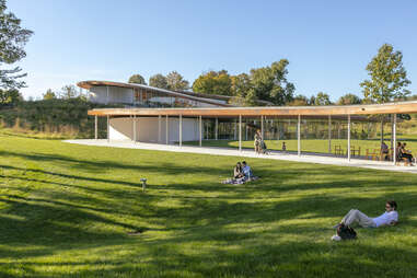 people enjoying the landscape of grace farms 