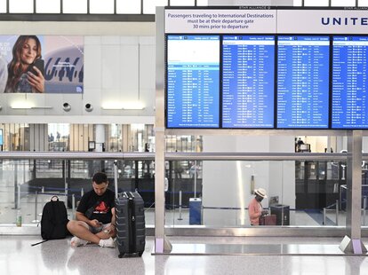 Passengers wait at the Newark Liberty International Airport as more than 2000 flights were canceled