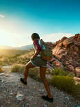 Woman hiking at Red Rock Canyon during sunset.