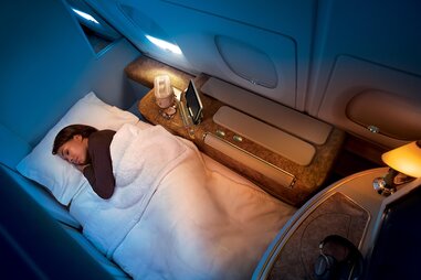 lady in bed on airplane
