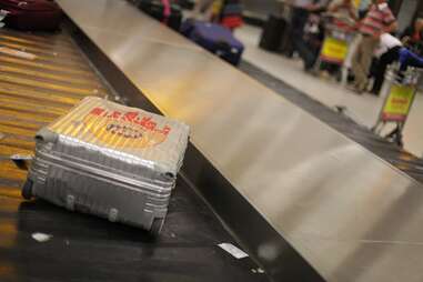 grey suitcase on luggage belt 