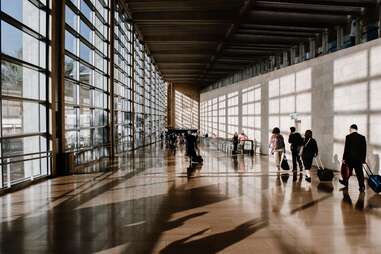 group of people walking through airport terminal