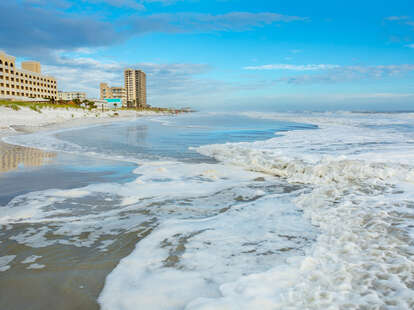 White sea foam on the beach in Jacksonville Florida, near Neptune Beach. 