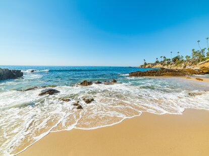 Rocks and sand in Laguna Beach, California on a beautiful day.