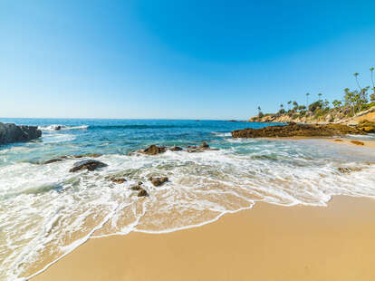 Rocks and sand in Laguna Beach, California on a beautiful day.
