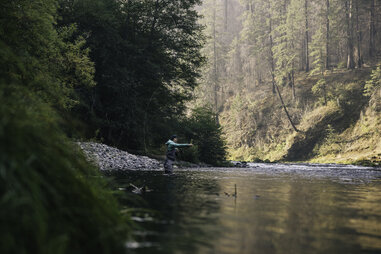 woman fly fishing in river