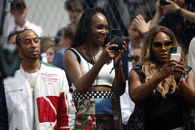 Ludacris, Venus Williams and Serena Williams watch the grid presentation prior to the F1 Grand Prix of Miami at Miami International Autodrome on May 07, 2023 in Miami, Florida.