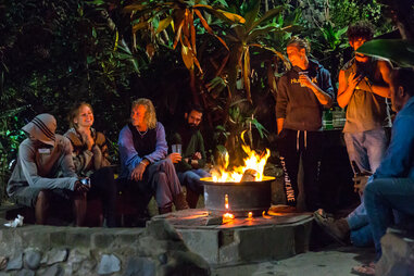 guests sit around a fire pit at the Coffee Shack