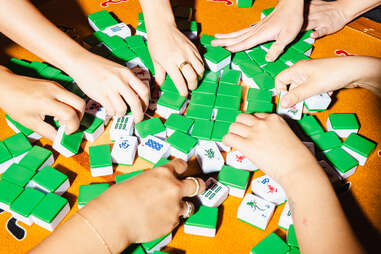 Players washing mahjong tiles