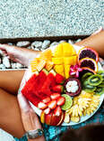 Woman holding bowl of fruit