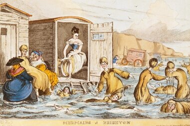 women sea-bathing with bathing machines in brighton, england