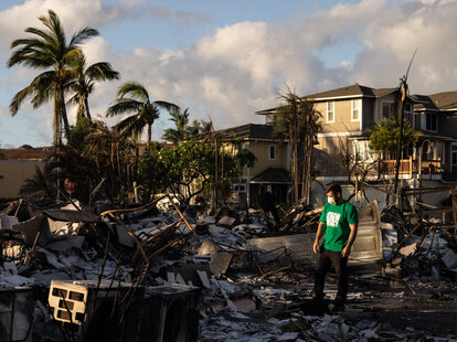 A Mercy Worldwide volunteer makes damage assessment of charred apartment complex in the aftermath of a wildfire in Lahaina, western Maui, Hawaii on August 12, 2023.