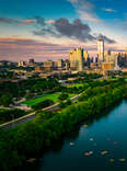 A colorful skyline at golden hour blue and pink clouds over Austin Texas USA Aerial Drone view above cityscape.