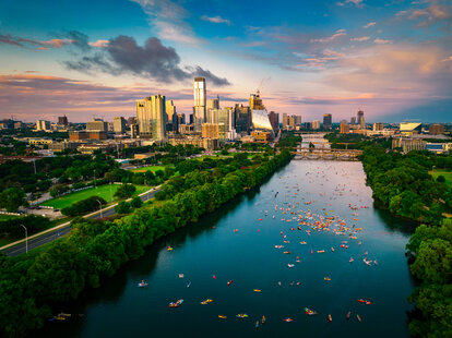A colorful skyline at golden hour blue and pink clouds over Austin Texas USA Aerial Drone view above cityscape.