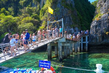 tourists on walkway to Maya Bay