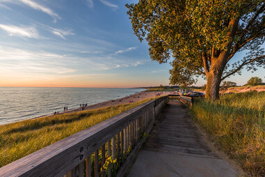 boardwalk leading to oval beach at sunset