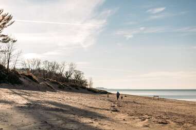 people walking along beach at indiana dunes 