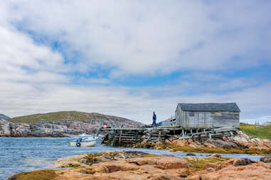 man walking on secluded dock in battle harbour