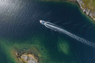 aerial view of boat driving to battle harbour