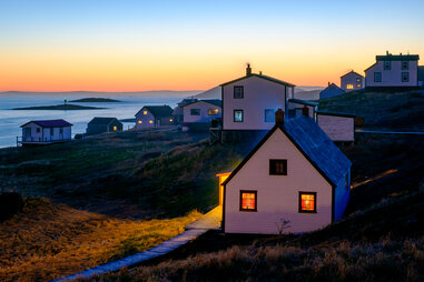 view of historic buildings in battle harbour at dusk