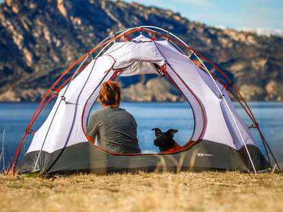 Woman and dog in tent