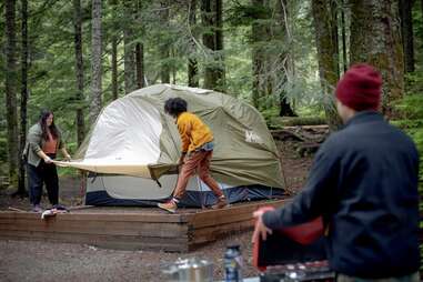 Family assembling a tent