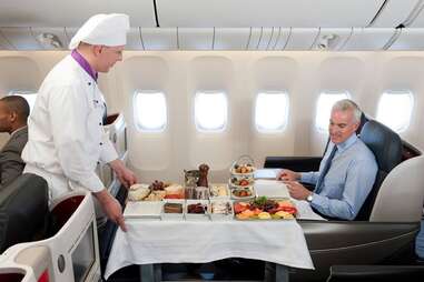 Chef serving food on an airplane