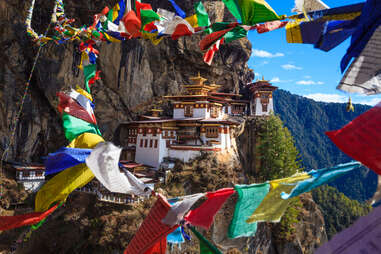 tigers nest monastery surrounded by colorful flags